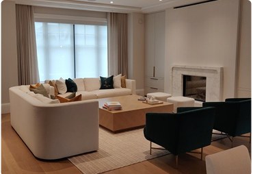 Living room with light-filtering roller shades and a fireplace