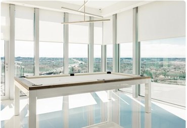Solar shades on a sunroom with a pool table and panoramic view