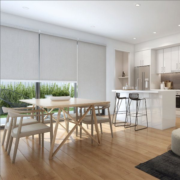 Indoor shades installed in a bright open-plan kitchen and dining area