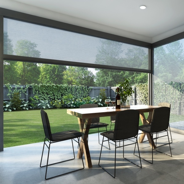 Outdoor motorized shades enclosing a patio for year-round use